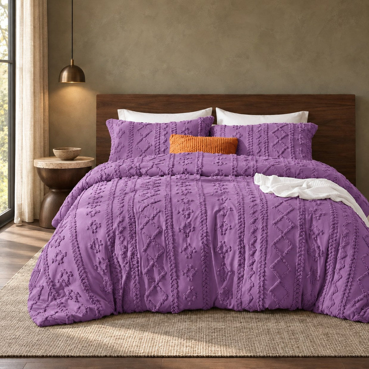Purple tufted comforter set on a bed